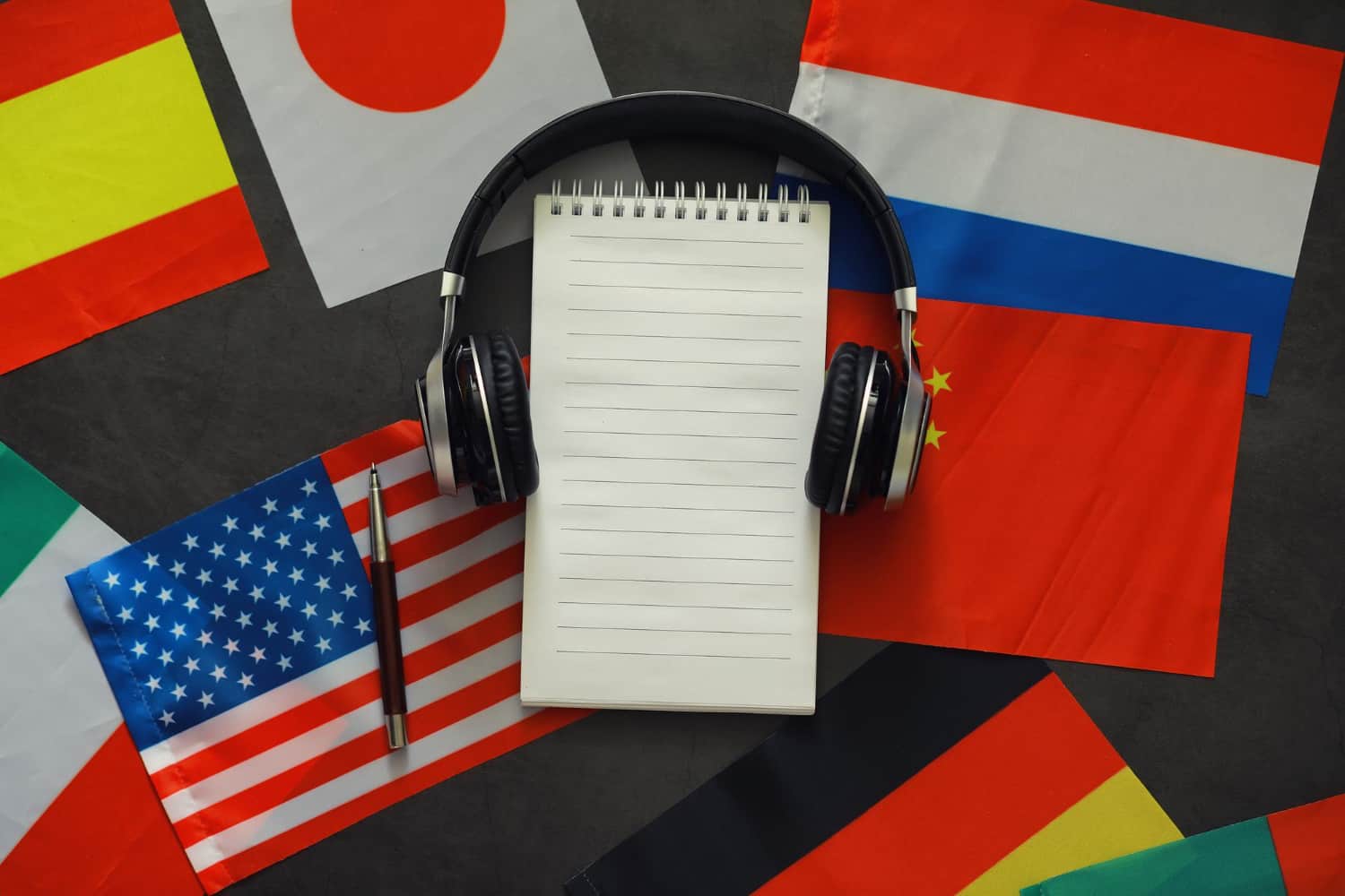 Notebook with headphones and flags